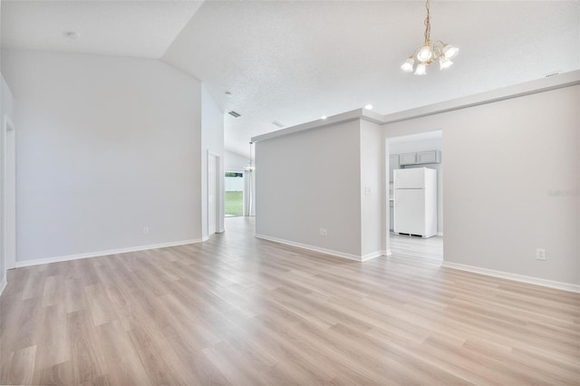 313 Cheshire Way, Davenport, FL 33897 - unfurnished living room with a chandelier, light wood-style floors, and lofted ceiling