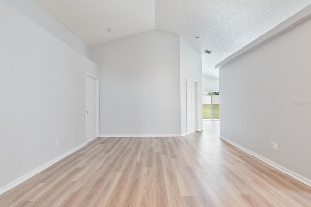 313 Cheshire Way, Davenport, FL 33897 - unfurnished room with light wood finished floors and high vaulted ceiling