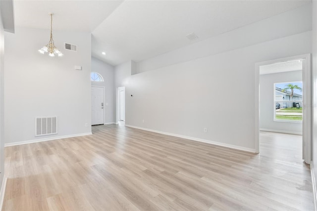 313 Cheshire Way, Davenport, FL 33897 - unfurnished living room featuring light wood finished floors, high vaulted ceiling, and a chandelier