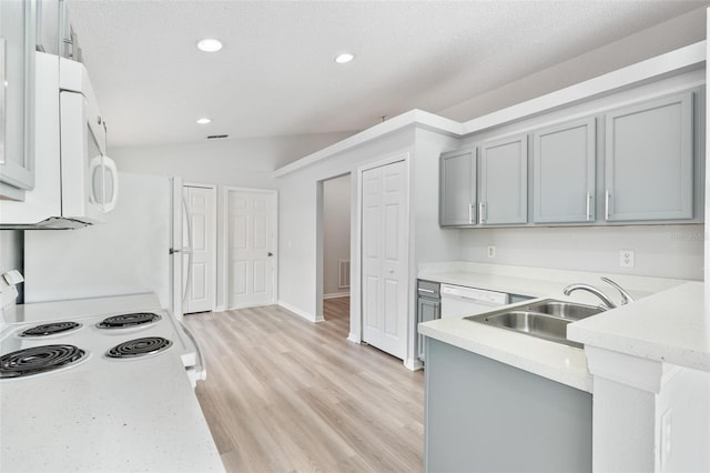 313 Cheshire Way, Davenport, FL 33897 - kitchen with gray cabinets, white appliances, recessed lighting, light wood finished floors, and vaulted ceiling