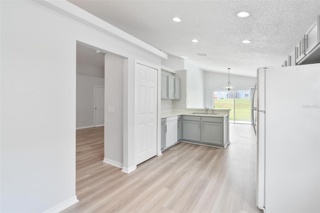 313 Cheshire Way, Davenport, FL 33897 - kitchen featuring white appliances, gray cabinets, recessed lighting, a chandelier, and light wood-style floors