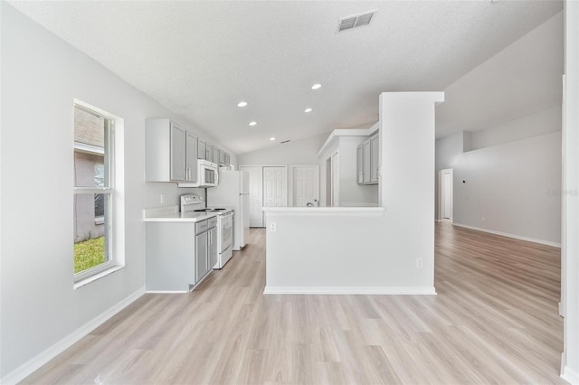 313 Cheshire Way, Davenport, FL 33897 - kitchen featuring white appliances, light wood-style floors, light countertops, recessed lighting, and open floor plan