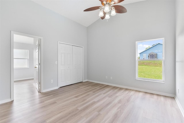 313 Cheshire Way, Davenport, FL 33897 - unfurnished bedroom featuring high vaulted ceiling, light wood-style floors, a closet, and a ceiling fan