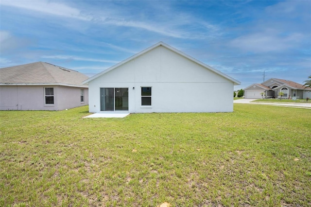 313 Cheshire Way, Davenport, FL 33897 - back of house featuring a lawn and stucco siding