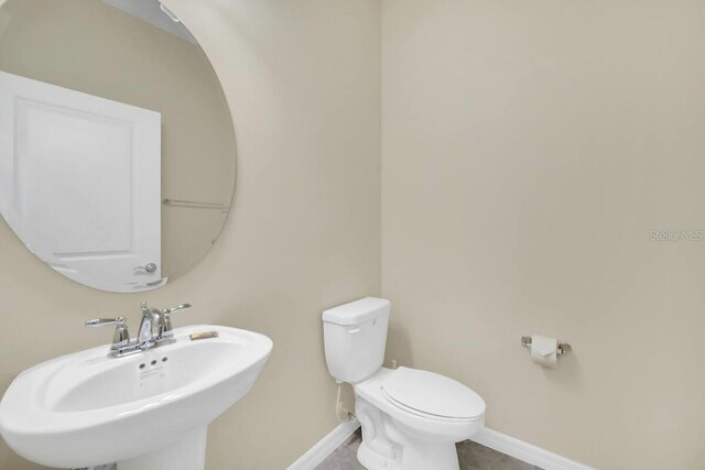 3448 Lilac Way, Davenport, FL 33897 - bathroom featuring a sink and baseboards