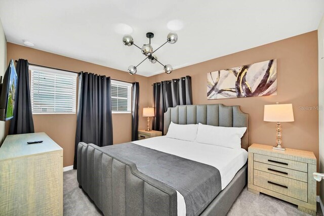 3448 Lilac Way, Davenport, FL 33897 - bedroom featuring light colored carpet and a chandelier