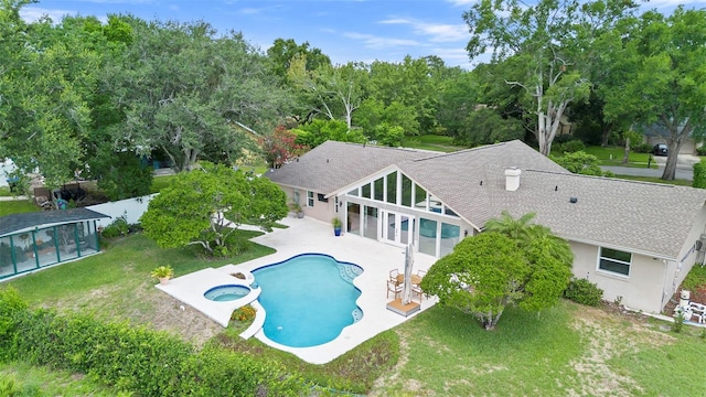 7905 Chad Ct, Orlando, FL 32835 - back of property with a patio area, roof with shingles, a fenced backyard, and a pool with connected hot tub