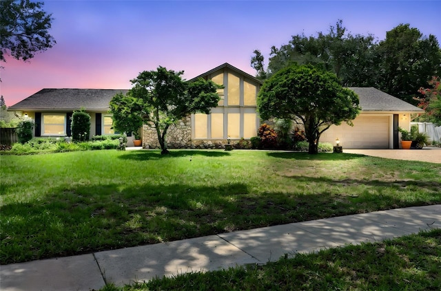 7905 Chad Ct, Orlando, FL 32835 - view of front facade featuring concrete driveway, a lawn, and a garage