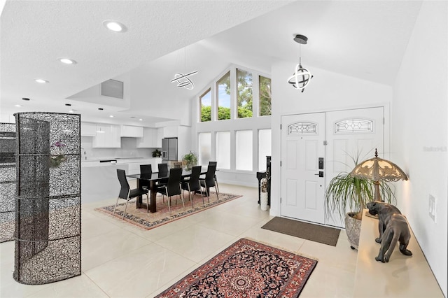 7905 Chad Ct, Orlando, FL 32835 - entryway with high vaulted ceiling, light tile patterned flooring, recessed lighting, and a textured ceiling