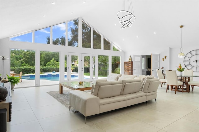 7905 Chad Ct, Orlando, FL 32835 - living room featuring high vaulted ceiling, plenty of natural light, light tile patterned floors, french doors, and recessed lighting