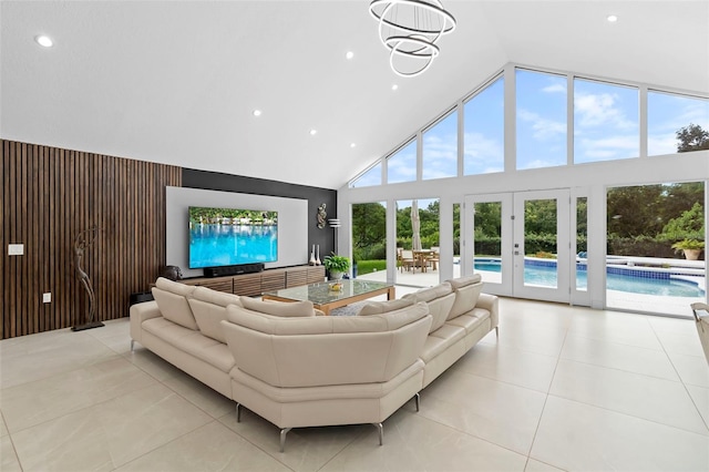 7905 Chad Ct, Orlando, FL 32835 - living room featuring high vaulted ceiling, recessed lighting, light tile patterned floors, and french doors