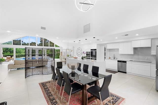 7905 Chad Ct, Orlando, FL 32835 - dining room with high vaulted ceiling, light tile patterned floors, and recessed lighting