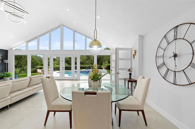 7905 Chad Ct, Orlando, FL 32835 - dining room featuring french doors, healthy amount of natural light, light tile patterned flooring, and high vaulted ceiling