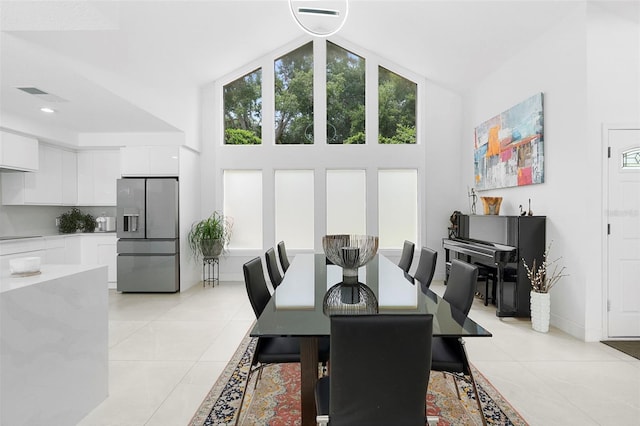 7905 Chad Ct, Orlando, FL 32835 - dining room featuring light tile patterned floors and high vaulted ceiling