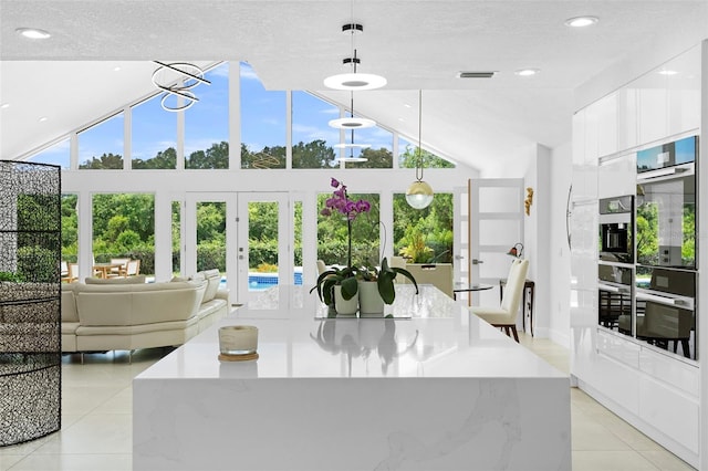 7905 Chad Ct, Orlando, FL 32835 - interior space featuring light tile patterned flooring, a textured ceiling, and french doors