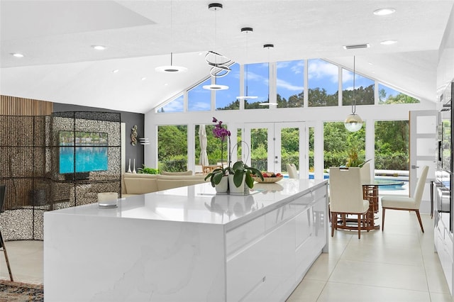 7905 Chad Ct, Orlando, FL 32835 - kitchen featuring modern cabinets, white cabinets, french doors, plenty of natural light, and recessed lighting