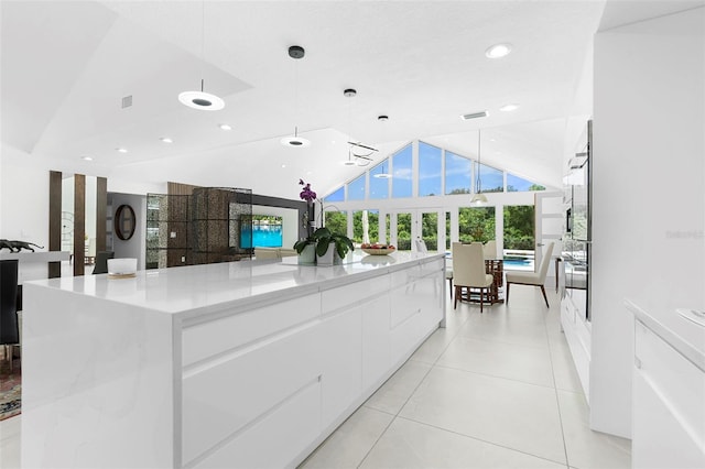 7905 Chad Ct, Orlando, FL 32835 - kitchen with modern cabinets, white cabinets, lofted ceiling, recessed lighting, and decorative light fixtures