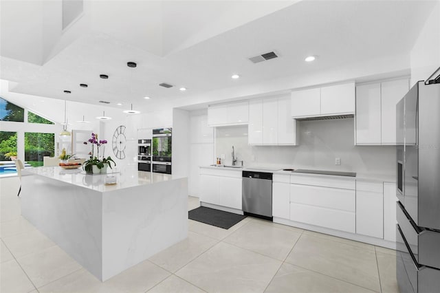 7905 Chad Ct, Orlando, FL 32835 - kitchen featuring appliances with stainless steel finishes, modern cabinets, white cabinets, recessed lighting, and light countertops