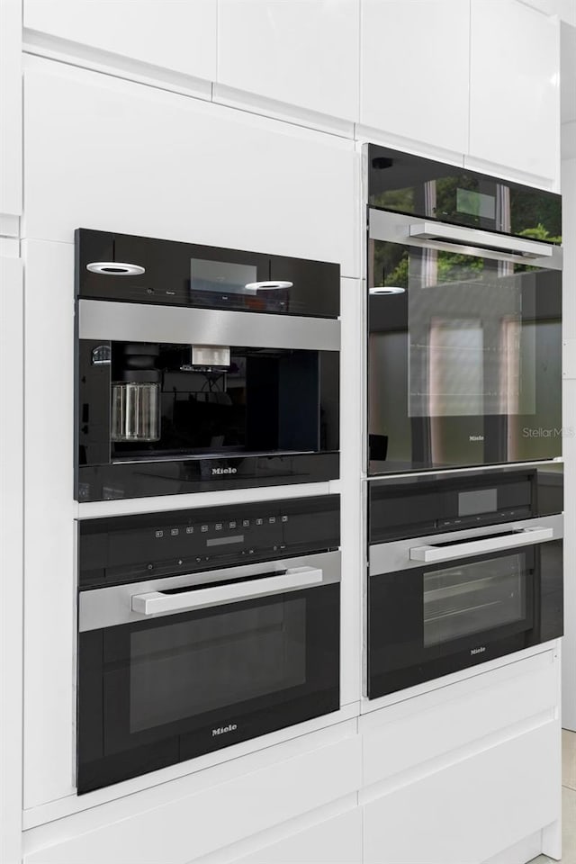 7905 Chad Ct, Orlando, FL 32835 - kitchen with white cabinetry and double oven