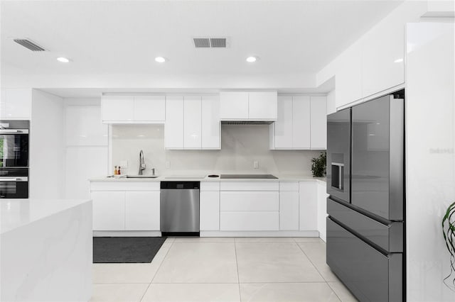 7905 Chad Ct, Orlando, FL 32835 - kitchen featuring appliances with stainless steel finishes, modern cabinets, white cabinetry, light countertops, and recessed lighting