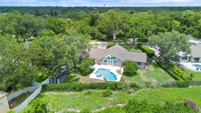 7905 Chad Ct, Orlando, FL 32835 - aerial view of property and surrounding area featuring a pool area and a heavily wooded area
