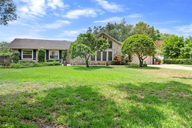 7905 Chad Ct, Orlando, FL 32835 - view of front facade featuring stone siding, driveway, a front lawn, and a garage