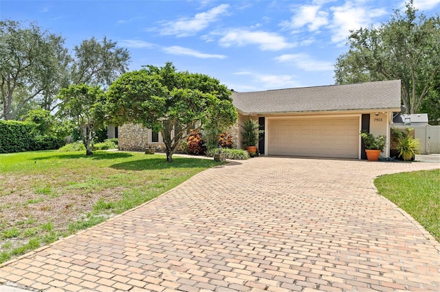 7905 Chad Ct, Orlando, FL 32835 - view of front of property featuring decorative driveway, a garage, and stucco siding