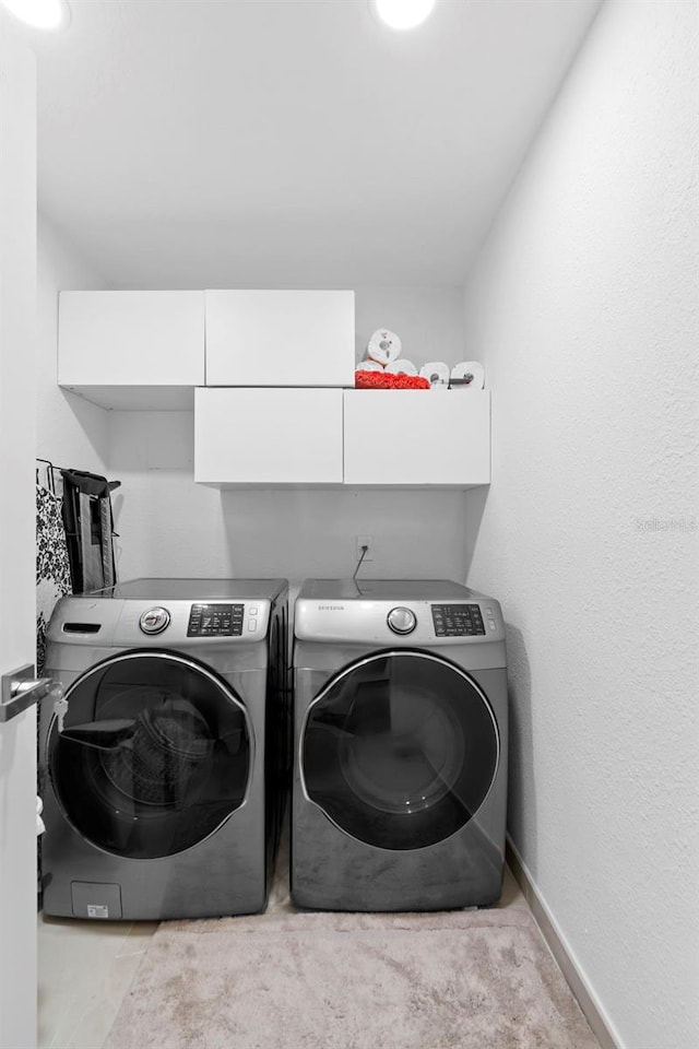 7905 Chad Ct, Orlando, FL 32835 - laundry area featuring washing machine and dryer and baseboards