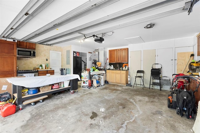 7905 Chad Ct, Orlando, FL 32835 - garage with freestanding refrigerator, a garage door opener, and electric panel