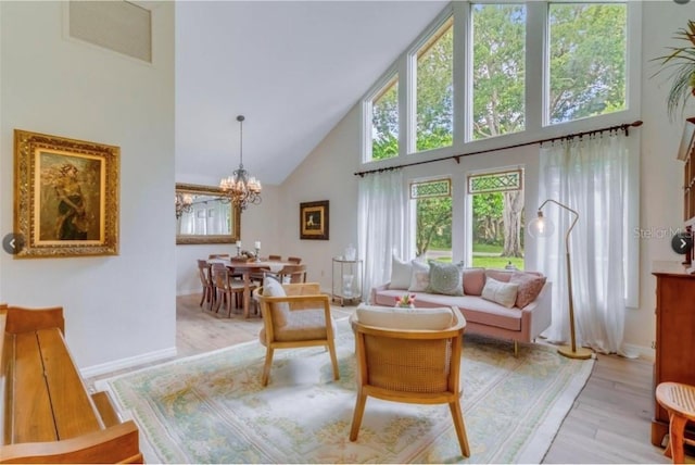 7905 Chad Ct, Orlando, FL 32835 - living area featuring high vaulted ceiling, light wood finished floors, and a chandelier