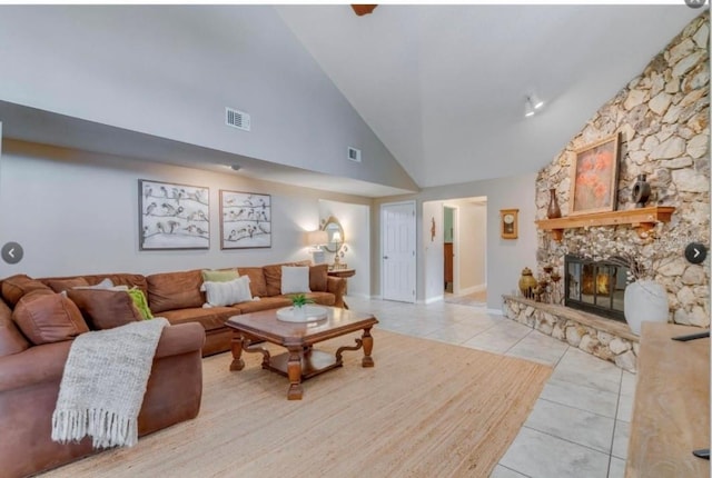 7905 Chad Ct, Orlando, FL 32835 - tiled living room featuring high vaulted ceiling and a stone fireplace