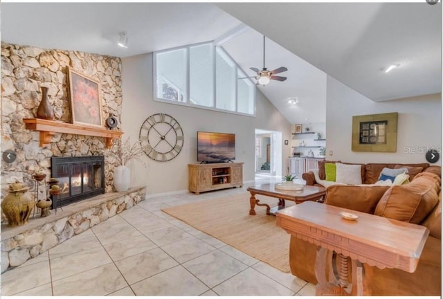 7905 Chad Ct, Orlando, FL 32835 - tiled living room featuring a ceiling fan, a stone fireplace, and high vaulted ceiling