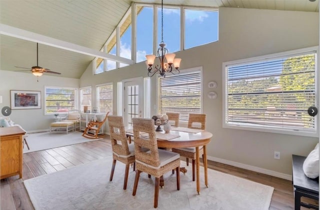 7905 Chad Ct, Orlando, FL 32835 - dining space featuring a chandelier, wood finished floors, high vaulted ceiling, and a ceiling fan