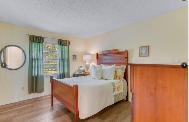 7905 Chad Ct, Orlando, FL 32835 - bedroom with wood finished floors and a textured ceiling