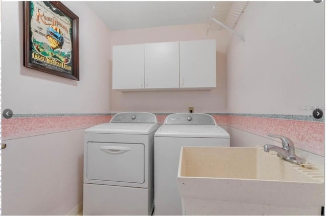 7905 Chad Ct, Orlando, FL 32835 - laundry area with washing machine and clothes dryer and cabinet space