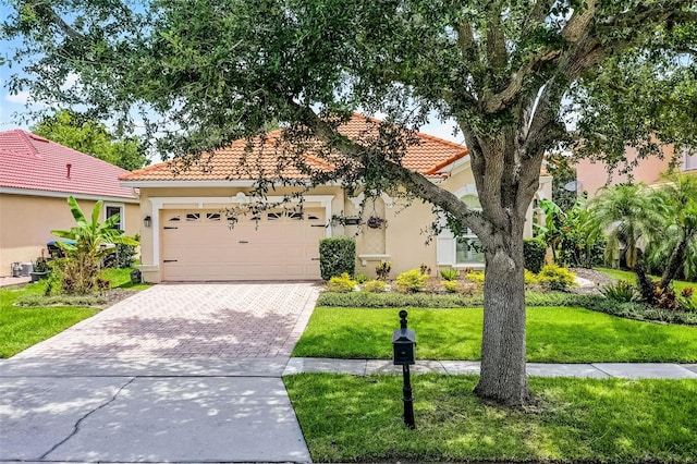 11337 Via Andiamo, Windermere, FL 34786 - view of front of property with an attached garage, decorative driveway, stucco siding, a tile roof, and a front lawn