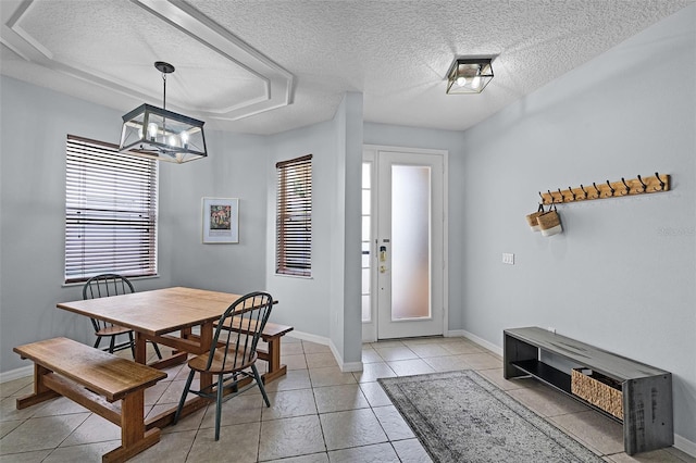 11337 Via Andiamo, Windermere, FL 34786 - dining area featuring a textured ceiling, light tile patterned floors, and a chandelier