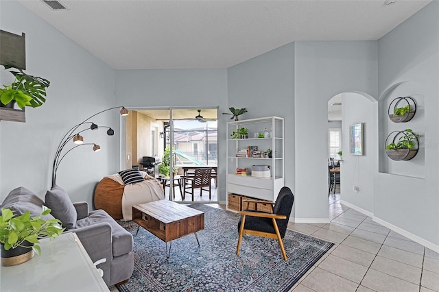 11337 Via Andiamo, Windermere, FL 34786 - living area with arched walkways, light tile patterned floors, and a ceiling fan