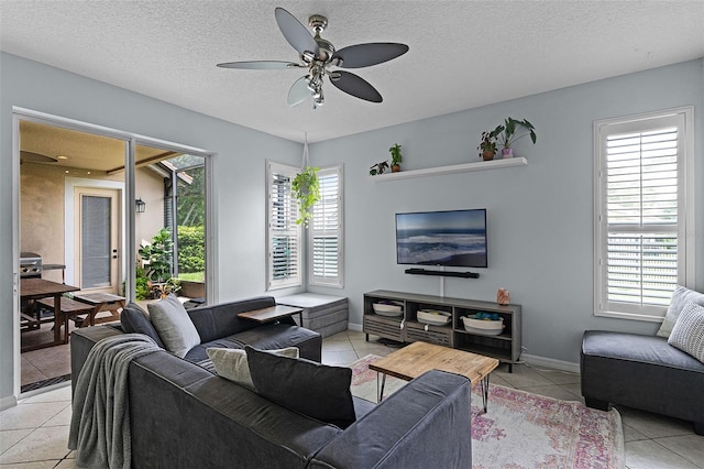 11337 Via Andiamo, Windermere, FL 34786 - living room featuring light tile patterned floors, a ceiling fan, plenty of natural light, and a textured ceiling