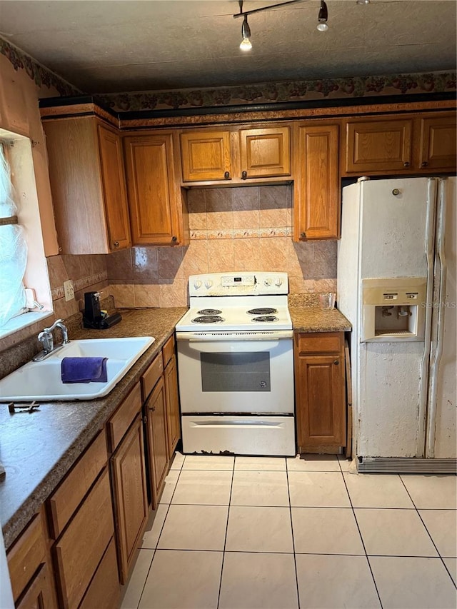 5300 Washington St Unit 340P, Hollywood, FL 33021 - kitchen with white appliances, brown cabinets, and light tile patterned flooring