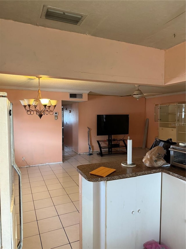 5300 Washington St Unit 340P, Hollywood, FL 33021 - kitchen with light tile patterned floors, dark countertops, freestanding refrigerator, a chandelier, and hanging light fixtures