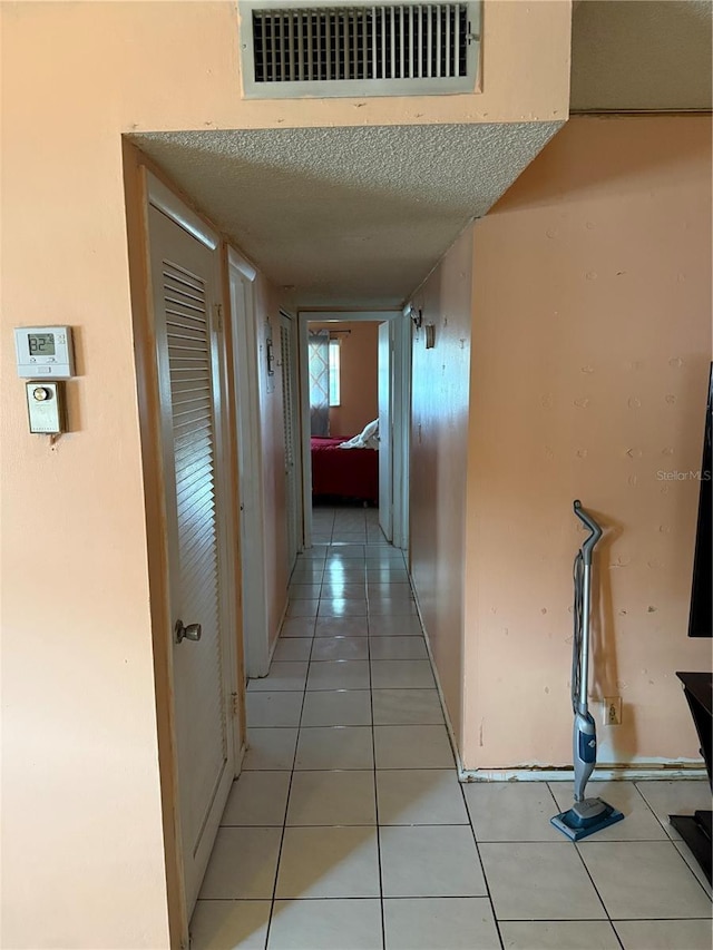 5300 Washington St Unit 340P, Hollywood, FL 33021 - hall featuring light tile patterned floors and a textured ceiling