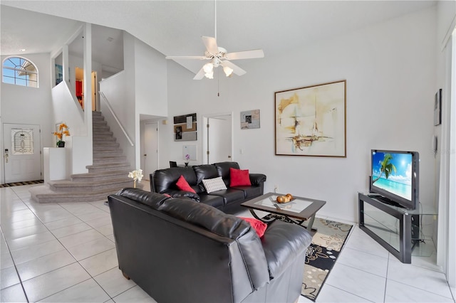 2979 Viscount Cir, Kissimmee, FL 34747 - living area with high vaulted ceiling, light tile patterned flooring, stairs, and ceiling fan