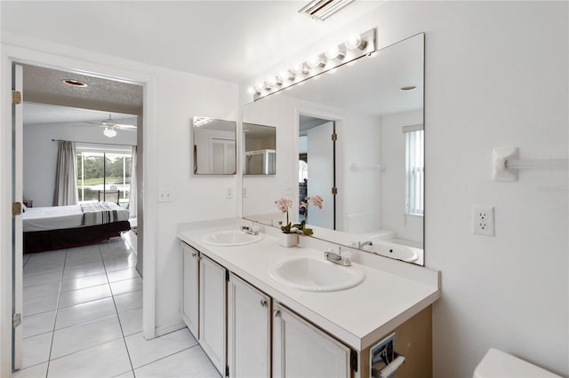 2979 Viscount Cir, Kissimmee, FL 34747 - bathroom with ensuite bathroom, double vanity, tile patterned floors, and ceiling fan