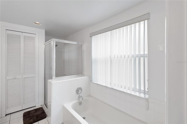 2979 Viscount Cir, Kissimmee, FL 34747 - bathroom with a closet, a stall shower, a bath, and tile patterned floors