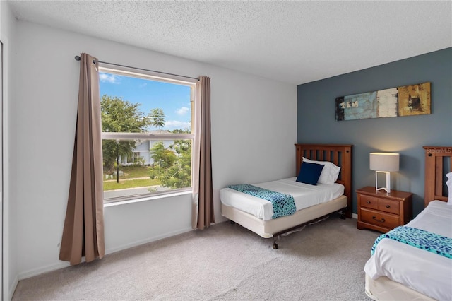 2979 Viscount Cir, Kissimmee, FL 34747 - carpeted bedroom with a textured ceiling and baseboards