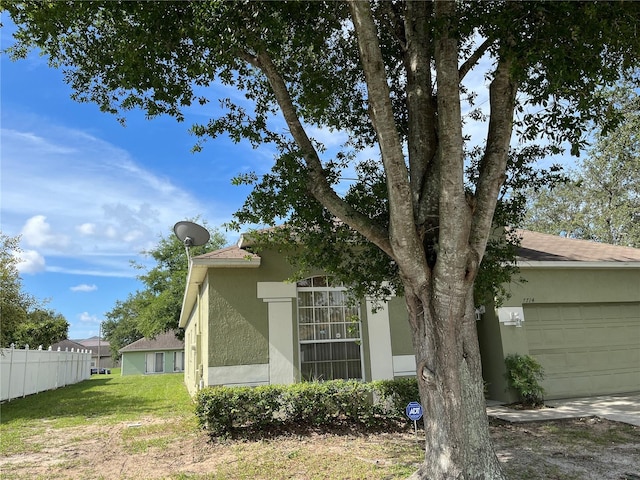 7714 Tanbier Dr, Orlando, FL 32818 - view of property exterior featuring stucco siding and a garage