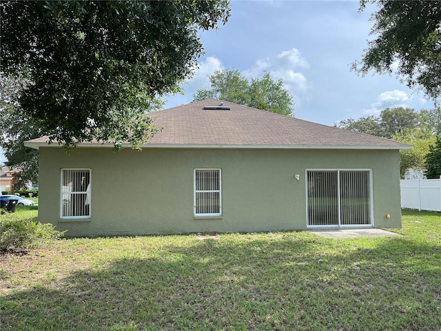 7714 Tanbier Dr, Orlando, FL 32818 - back of house featuring stucco siding and a shingled roof