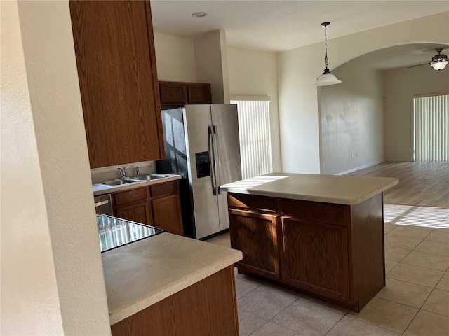 7714 Tanbier Dr, Orlando, FL 32818 - kitchen with stainless steel fridge with ice dispenser, ceiling fan, light tile patterned flooring, and hanging light fixtures