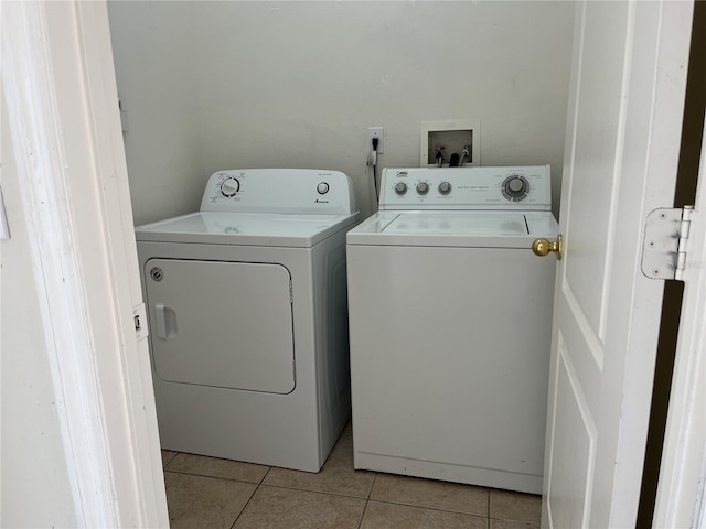 7714 Tanbier Dr, Orlando, FL 32818 - laundry area featuring washer and clothes dryer and light tile patterned flooring